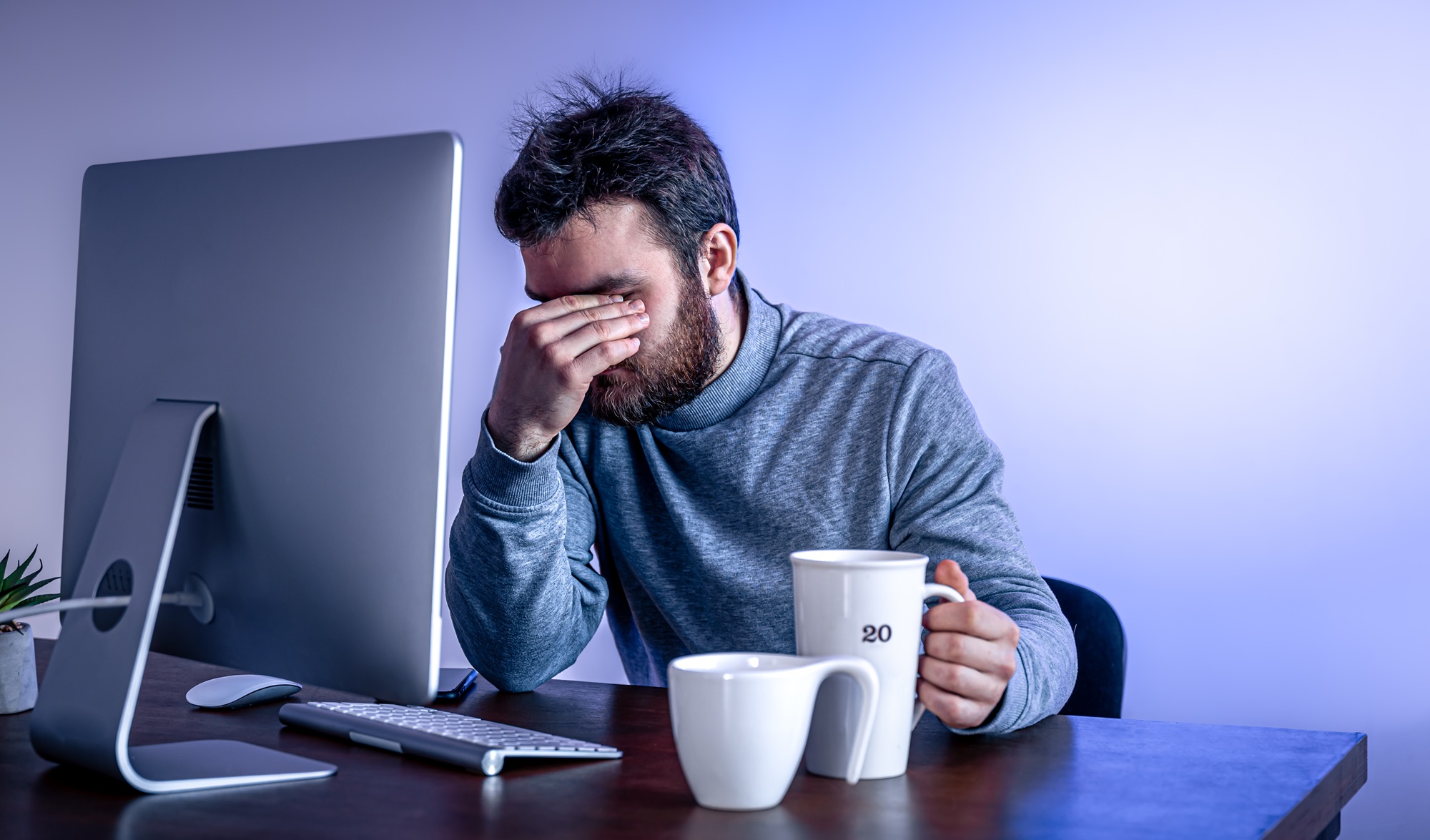 Tired developer at a computer